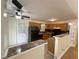 Well-lit kitchen with oak cabinets, black appliances, and an open counter looking into the living area at 214 Sweetwater Cir, Powder Springs, GA 30127
