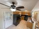 Oak-cabinet kitchen with black appliances featuring a breakfast bar with abundant light and backyard views at 214 Sweetwater Cir, Powder Springs, GA 30127