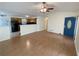 Spacious living room with hardwood floors and blue door, open to the kitchen area at 214 Sweetwater Cir, Powder Springs, GA 30127
