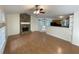 Spacious living room with hardwood floors and a stone fireplace open to the kitchen area at 214 Sweetwater Cir, Powder Springs, GA 30127