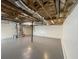 Large unfinished basement with painted floors, open ceiling with insulated pipes, and lots of potential at 214 Sweetwater Cir, Powder Springs, GA 30127