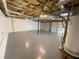 Spacious unfinished basement with painted floors, open ceiling, and utility hookups at 214 Sweetwater Cir, Powder Springs, GA 30127