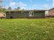 An expansive green backyard featuring a patio and a brick house at 3653 Mecklinburg Pl, Decatur, GA 30032
