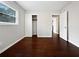 Bedroom with hardwood floors, neutral walls, closet and adjacent room entrances at 3653 Mecklinburg Pl, Decatur, GA 30032