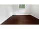 A bedroom featuring hardwood floors and a single window that provides ample lighting at 3653 Mecklinburg Pl, Decatur, GA 30032