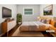 Stylishly staged main bedroom with hardwood floors and modern furniture at 3653 Mecklinburg Pl, Decatur, GA 30032