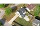 Aerial view features home with spacious yard including a gazebo, a fire pit, and mature trees at 1700 Conductor Ln, Conyers, GA 30013