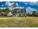 Lovely two-story home with black shutters, well-manicured landscaping, and a spacious front yard at 1700 Conductor Ln, Conyers, GA 30013