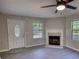This is a bright open living room with neutral paint, an updated floor and a fireplace at 1700 Conductor Ln, Conyers, GA 30013