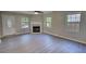 This is a brightly lit room that is spacious, with a fireplace and updated flooring at 1700 Conductor Ln, Conyers, GA 30013