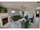 The room is virtually staged with a couch and chairs, along with a fireplace and flatscreen TV at 1700 Conductor Ln, Conyers, GA 30013