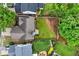 Aerial view of the house showcasing the layout of the backyard, patio, mature trees, and surrounding landscape at 449 Highlands Loop, Woodstock, GA 30188