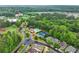 Aerial view highlighting community amenities, pool, tennis courts, landscaping, and surrounding neighborhood with tree-lined streets at 449 Highlands Loop, Woodstock, GA 30188