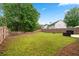 Expansive backyard surrounded by a wooden fence and mature trees at 449 Highlands Loop, Woodstock, GA 30188