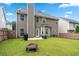 View of the home's backyard with a well-maintained lawn and a charming patio area, perfect for outdoor relaxation and entertainment at 449 Highlands Loop, Woodstock, GA 30188