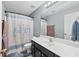 Bathroom featuring a shower-tub combo, modern vanity, and cute decorative accents at 449 Highlands Loop, Woodstock, GA 30188