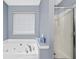 Bathroom with a large soaking tub and a glass-enclosed shower at 449 Highlands Loop, Woodstock, GA 30188