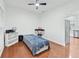Bright bedroom with hardwood floors, ceiling fan, and a view to the kitchen at 449 Highlands Loop, Woodstock, GA 30188