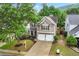 Charming two-story home boasts a manicured lawn, a two-car garage, and tasteful landscaping, creating curb appeal at 449 Highlands Loop, Woodstock, GA 30188