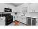 Modern kitchen with white cabinets, sleek countertops, and stainless steel appliances at 449 Highlands Loop, Woodstock, GA 30188