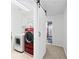 Convenient laundry room featuring a sliding barn door and updated washer and dryer at 449 Highlands Loop, Woodstock, GA 30188
