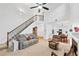 Bright open living area features high ceilings, a fireplace, and seamless flow to the dining area at 449 Highlands Loop, Woodstock, GA 30188