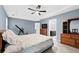 Main bedroom with a ceiling fan, neutral carpet, and access to the bathroom at 449 Highlands Loop, Woodstock, GA 30188