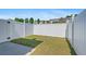 Enclosed backyard featuring a well maintained lawn, concrete patio, and a white privacy fence at 577 Cypher Dr, Suwanee, GA 30024