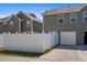 Backyard featuring a white privacy fence, an adjacent garage, and a paved driveway at 577 Cypher Dr, Suwanee, GA 30024