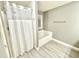 Clean bathroom showcasing a shower with clear curtain and separate tub at 577 Cypher Dr, Suwanee, GA 30024