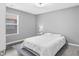 Cozy bedroom with a white comforter, a large window, and neutral walls at 577 Cypher Dr, Suwanee, GA 30024