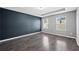 Spacious bedroom featuring sleek floors, a tray ceiling, and two windows at 577 Cypher Dr, Suwanee, GA 30024