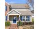 Charming home featuring a covered entrance, well-manicured landscaping, and a classic architectural design at 577 Cypher Dr, Suwanee, GA 30024