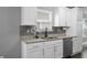 Kitchen area boasts white cabinets, granite countertops, and stainless steel appliances at 577 Cypher Dr, Suwanee, GA 30024