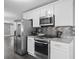 Modern kitchen with stainless steel appliances, granite countertops and ample cabinet space at 577 Cypher Dr, Suwanee, GA 30024