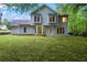 This home boasts a sprawling green backyard with a patio and access to lush surrounding trees at 6939 Waters Edge Dr, Stone Mountain, GA 30087