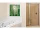Bathroom with a jetted tub, large window with wooded views, and glass-enclosed shower at 6939 Waters Edge Dr, Stone Mountain, GA 30087
