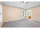 Bedroom with vaulted ceiling, neutral carpet, and a doorway to the bathroom at 6939 Waters Edge Dr, Stone Mountain, GA 30087
