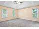 Spacious bedroom with a vaulted ceiling, neutral carpeting and three large windows at 6939 Waters Edge Dr, Stone Mountain, GA 30087