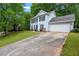 Two-story traditional home with a driveway, two-car garage, and beautiful landscaping at 6939 Waters Edge Dr, Stone Mountain, GA 30087