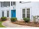 Close up of the front door featuring the blue door and manicured landscaping at 6939 Waters Edge Dr, Stone Mountain, GA 30087