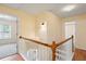 Upstairs hallway featuring wood floors, natural light, and neutral walls at 6939 Waters Edge Dr, Stone Mountain, GA 30087