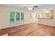 Open-concept living room with wood floors and ample natural light from large windows at 6939 Waters Edge Dr, Stone Mountain, GA 30087