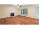 Living room features a fireplace, hardwood floors, and natural light from a large window at 6939 Waters Edge Dr, Stone Mountain, GA 30087