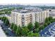 Stunning aerial view of a mid-rise apartment complex surrounded by lush greenery with the city skyline in the background at 711 Cosmopolitan Ne Dr # 123, Atlanta, GA 30324