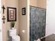 Well-lit bathroom with a framed mirror and shower with a patterned curtain at 711 Cosmopolitan Ne Dr # 123, Atlanta, GA 30324