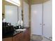 Bathroom vanity featuring modern sink, cabinets, and three doors providing access to storage space at 711 Cosmopolitan Ne Dr # 123, Atlanta, GA 30324