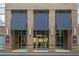 Welcoming entrance to 711 Cosmopolitan building featuring brick facade, modern awning and glass door entryway at 711 Cosmopolitan Ne Dr # 123, Atlanta, GA 30324