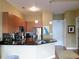 Well-lit kitchen with stainless steel appliances, wood cabinets, black counters, and an island with pendant lights at 711 Cosmopolitan Ne Dr # 123, Atlanta, GA 30324