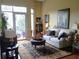 Cozy living room with comfortable seating, a large window to the balcony, and stylish decor at 711 Cosmopolitan Ne Dr # 123, Atlanta, GA 30324